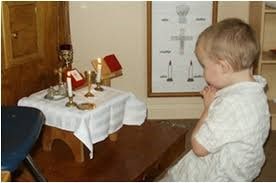 Young Child Praying at Altar in Religious Education Class